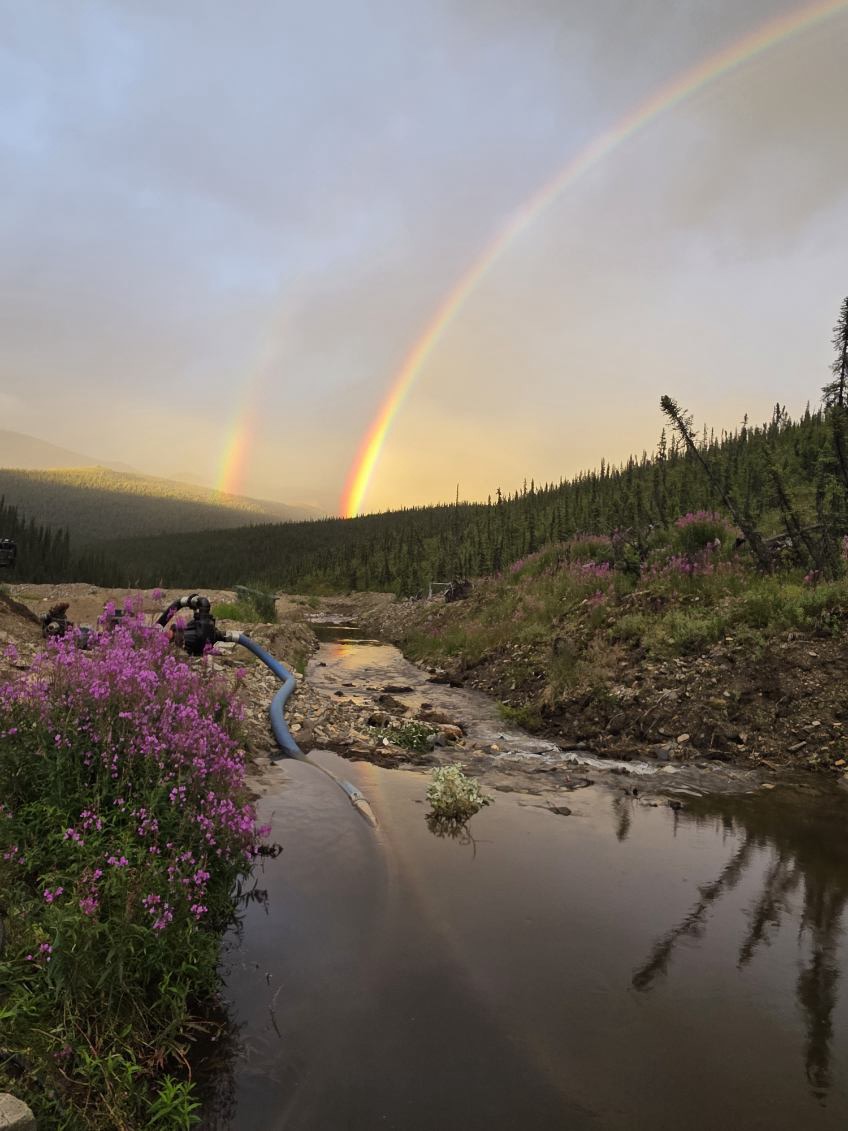 Rainbow stretching over the claim and equipment.