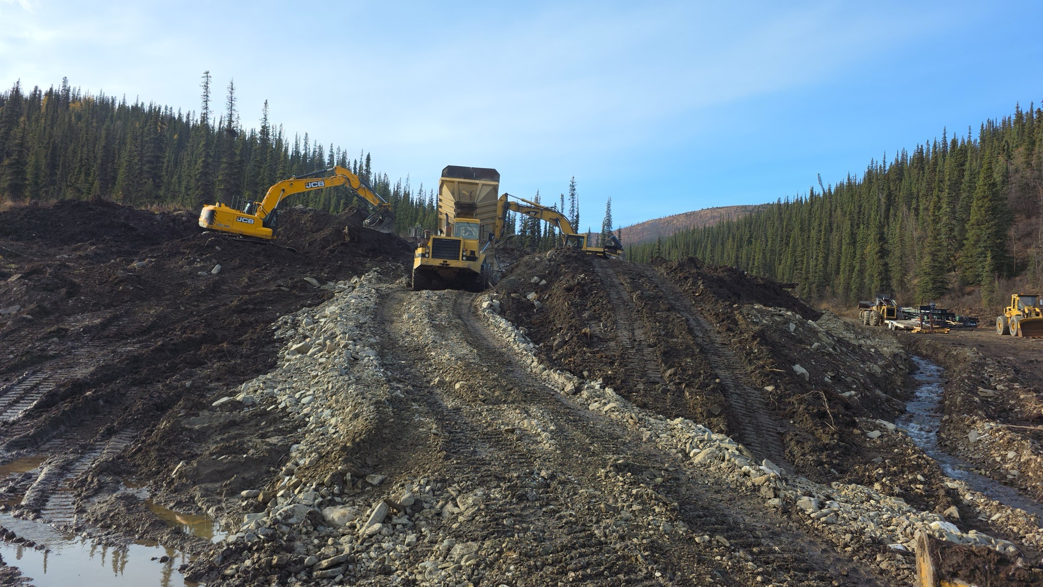 Wide view of a surface placer mining area with equipment.